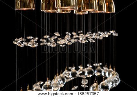 Modern Chandelier for interior of the living room. a bunch of crystal balls isolated on black background. Many light bulbs