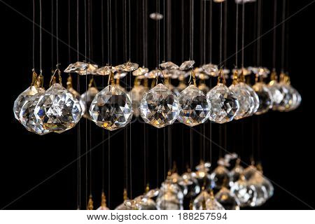 Modern Chandelier for interior of the living room. a bunch of crystal balls isolated on black background. Many light bulbs