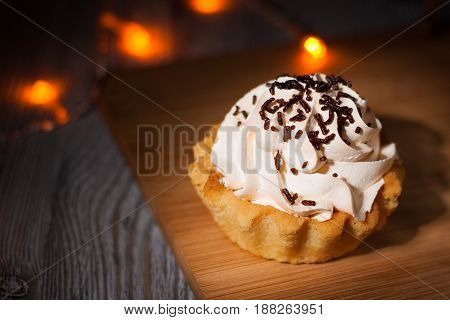 A Small Cake On A Wooden Table.