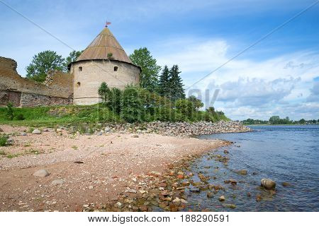 View of the Royal tower of the old Oreshek fortress and the shore of the Neva river sunny August day. Shlisselburg, Russia