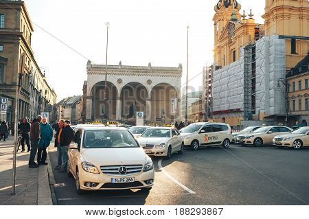 Munich, Germany, December 29, 2016: Many traditional Bavarian taxis at the Odeonsplatz square in the center of Munich. Transportation of passengers. Everyday life in Munich.