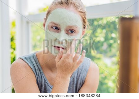Spa Woman Applying Facial Green Clay Mask. Beauty Treatments. Close-up Portrait Of Beautiful Girl Ap
