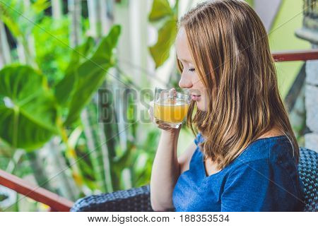 Young Beautiful Redhead Woman Sitting In A Cafe Drinking A Delicious Morning Ginger Tea In A Cafe