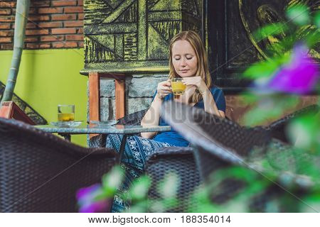 Young Beautiful Redhead Woman Sitting In A Cafe Drinking A Delicious Morning Ginger Tea In A Cafe