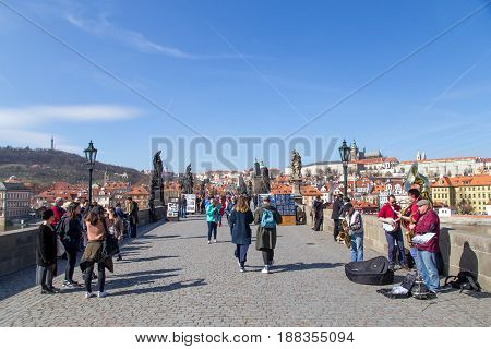 Prague, Czech Republic - March 16, 2017: People walking on the damous Charles Bridge in the city centre