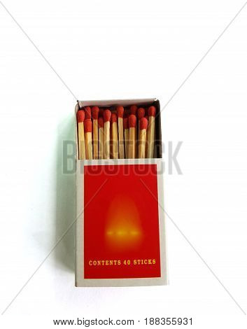 Matches in a matchbox on white background,Open matchbox,Top close-up view on highlighted wooden table.