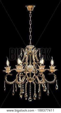 Classic Chandelier for interior decoration of the living room. Large chandelier close-up details decorated with crystals isolated on black background. Gold modern a piece of interior for designers.