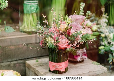 Tenderless bouquet of pink and white roses. petals and other flovers in vase