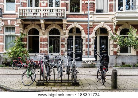 Amsterdam Netherlands - August 09 2016 Bicycles and typical houses in Oude Pijp nicknamed the Quartier Latin a neighborhood in Amsterdam a cloudy day of summer