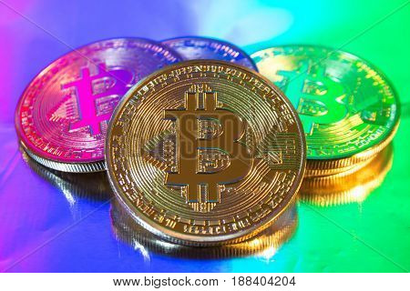 Photo of cryptocurrency physical golden bitcoin coin on colorful background