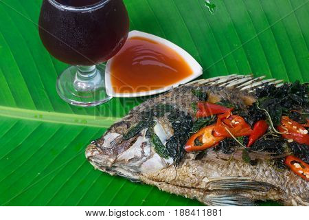 Fried fish (Tilapia) isolate banana leaf,thai food