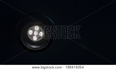 Energy saving led spotlight with flare up in the ceiling in the dark with copy space