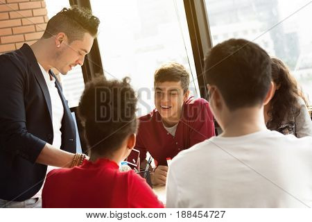 Young casual multiethnic business people paying attention to their friend in group discussion (meeting)