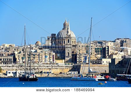 VALLETTA, MALTA - MARCH 30, 2017 - View of St Pauls Anglican Cathedral and the Basilica of Our Lady of Mount Carmel seen from the Grand Harbour Valletta Malta Europe, March 30, 2017.