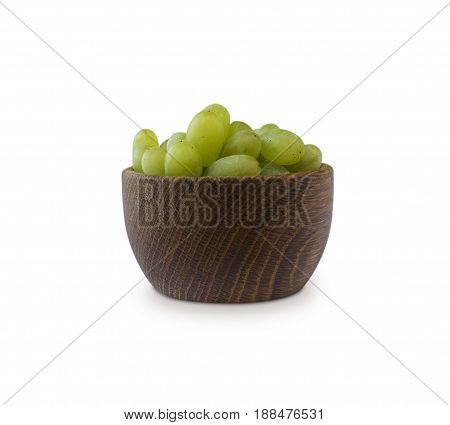 Grapes in a wooden bowl isolated on white background. Green grapes Kish Mish.