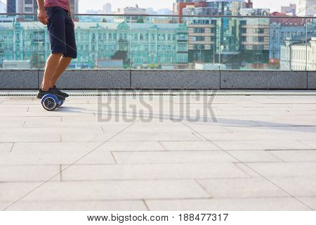 Male legs on gyroboard. Mini segway in the city. How to ride a hoverboard.
