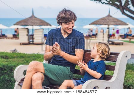 Father And Son Eat Fried Sweet Potatoes In The Park. Junk Food Concept