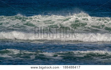 waves breaking into the shore in the late afternoon