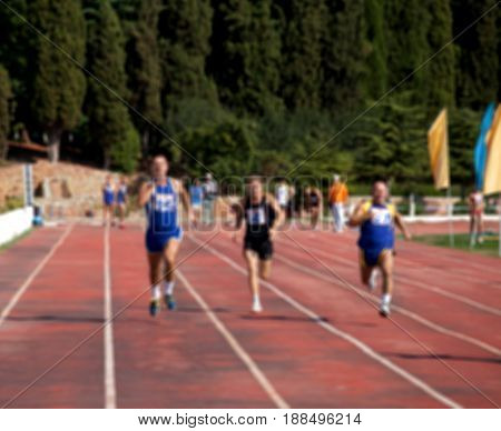 Blurred View Of Man Athletic Running Competition At Stadium