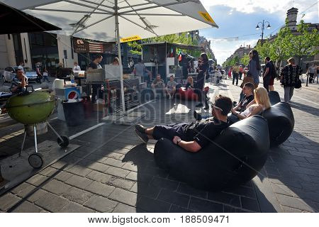 VILNIUS - MAY 20: Unidentified people relaxing in Vilnius Old Town outdoor cafe on May 20 2017 in Vilnius Lithuania. Vilnius is the capital of Lithuania and its largest city.