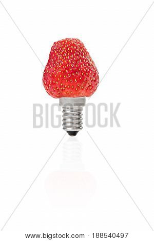 Conceptual photo - ripe strawberry with a socle from a light bulb, isolated on a white background