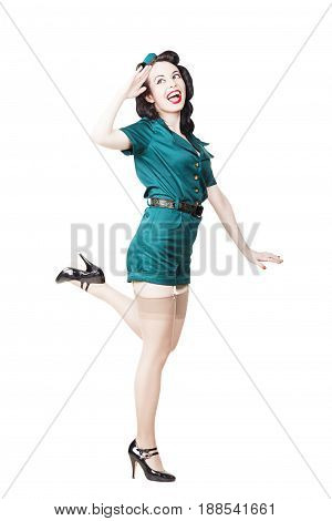 Portrait of Beautiful Brunette with black hair. Pin up Female Dressed in military clothing Uniform and Garrison cap saluting. Army Pin-up Girl Concept
