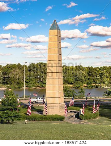 Gadsden Alabama USA - May 25 2017: The Spirit of American Citizenship Monument decorated for Memorial Day with the Coosa River in the background This monument honors the citizens and history of the area.