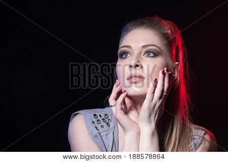 Portrait Of Actress In A Grey Dress On Black Stage