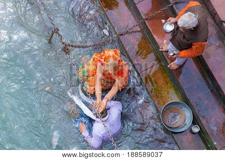 Haridwar, India - March 11, 2017: Unidentified People Bathing And Taking Ablutions In The Ganges Riv