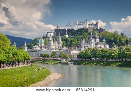 Classic postcard view of the historic city of Salzburg with famous Festung Hohensalzburg reflecting in beautiful Salzach river in summer Salzburger Land Austria