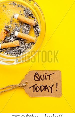 No Smoking - Time to Quit - with ashtray and handwritten tag on yellow background