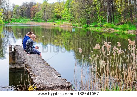 Young Fishermen In Pond In Traku Voke Public Park Vilnius