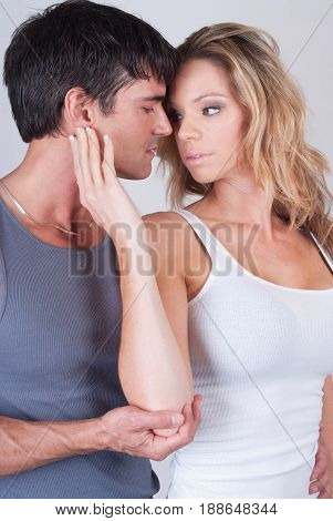 The sexy couple is in a hot embrace.