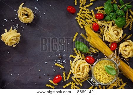 Ingredients For The Preparation Of Italian Pasta - Spaghetti, Fusilli, Fettuccine, Basil, Cherry Tom