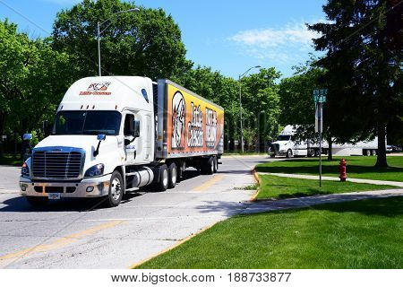 KALISPELL, MONTANA, USA - May 23, 2017: A Little Caesars Pizza semi-truck convoys with another semi through the streets of Kalispell