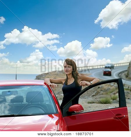 beautiful girl next door with a red car.