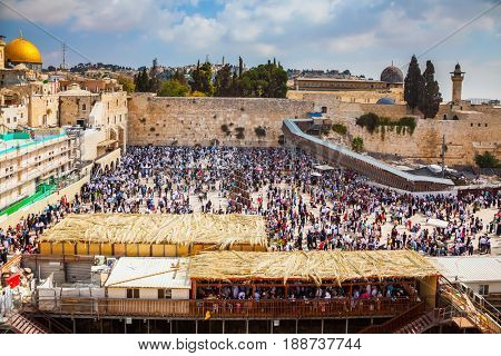 The huge crowd of Jews for a prayer has gathered on the square. Western Wall of the Temple. Autumn holiday of Sukkot in Jerusalem. 