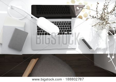 Creative workplace with laptop on windowsill in modern room