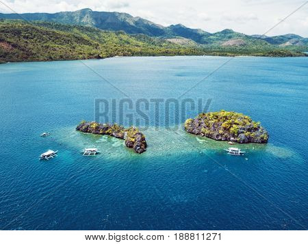 Aerial view of small islands with boats in Coron Bay. Palawan May 2017