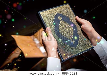 Muslim man hands holding rosary with quraan