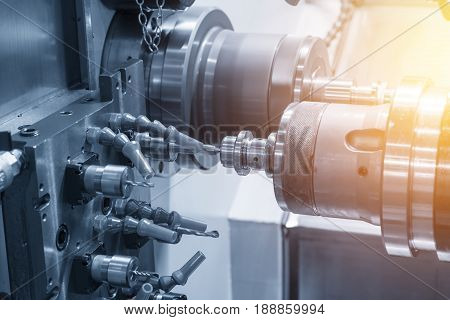 The CNC lathe machine or Turning machine drilling the metal rod with the drill tool and center drill tool .The hi-technology machining concept.