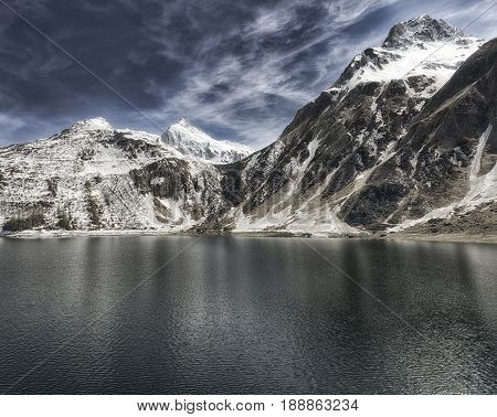 Alpine lake in the Formazza valley with blue sky and clouds in a spring sunny day Piedmont - Italy