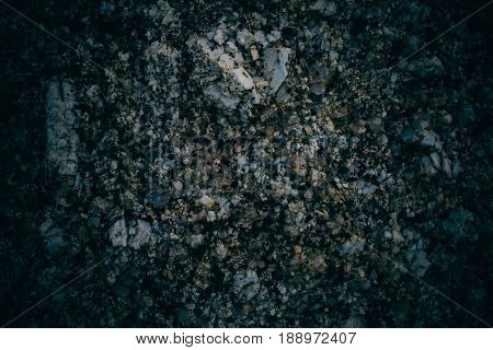 Experimental stone texture and background. Dark rough rock texture. Abstract texture and background for designers. Macro view of dark rough rock floor in vintage style.