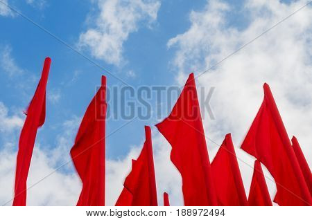 Group of red flags on blye sky background