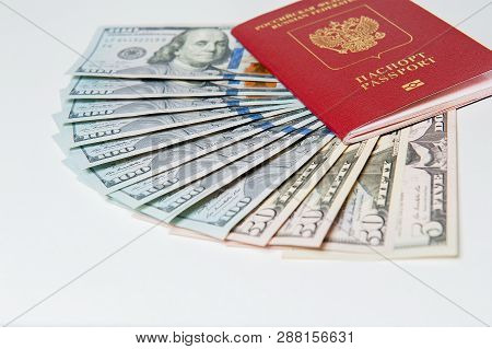 Biometric Passport And Two Banknotes For A Hundred Dollars Visa Free Travel. Travel Expenses Concept
