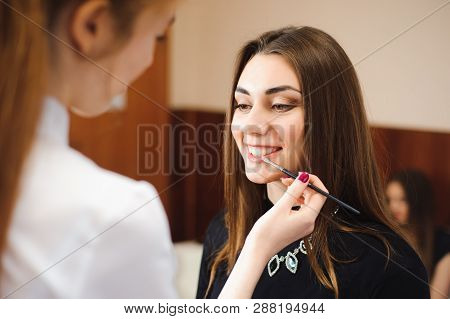 Make Up Artist Doing Professional Make Up Of Young Woman.
