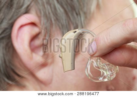 Closeup Senior Woman With Hearing Aid In Her Ear. Health Care, Hear Amplify, Device For The Deaf.