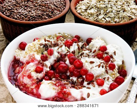 Delicious And Healthy Breakfast With Oat Flakes, Yoghurt, Flaxseed And Cowberry. Energy Breakfast Co