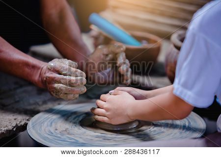 Close-up To Hands Of Potter Teacher And Child