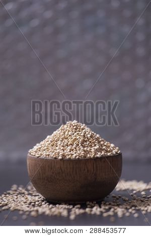 Quinoa Grains In Wooden Bowl On Black Background